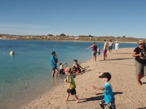 Coral Bay Accommodation in the background Lots of people and the town in the background